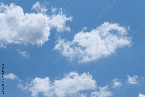 Blue sky background with white clouds. Cropped shot  horizontal  free space. Concept of natural beauty.