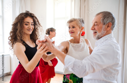Fototapeta Naklejka Na Ścianę i Meble -  Group of senior people in dancing class with dance teacher.