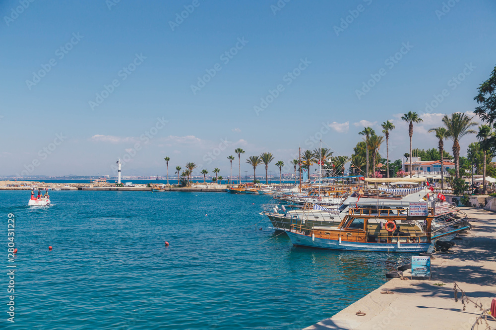 SIDE, TURKEY - JULY 28, 2017: Tourist harbor, Mediterranean resort in Side in a beautiful summer day, Antalya, Turkey