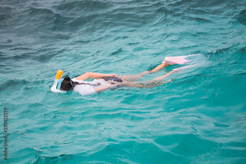 Snorkeling tourist in clear blue water paradise