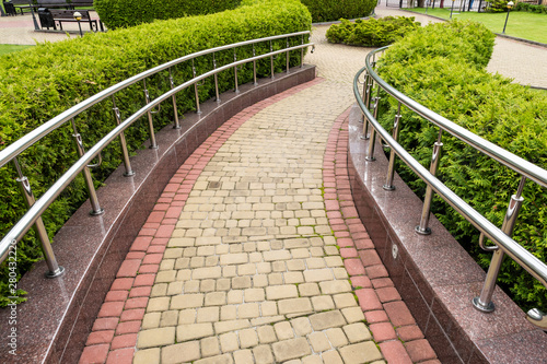 walkway with chrome steel railings in landscape design