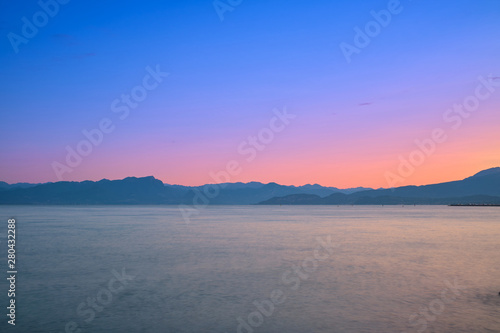 Sunrise in the small Italian town of Pischera on Lake Garda, Italy. Panoramic view of the city sunrise.