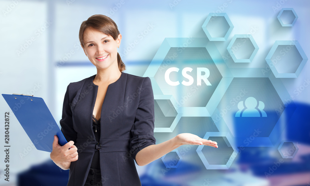The concept of business, technology, the Internet and the network. A young entrepreneur working on a virtual screen of the future and sees the inscription: CSR The concept of business, technology, the Internet and the network. A young entrepreneur working on a virtual screen of the future and sees the inscription: CSR