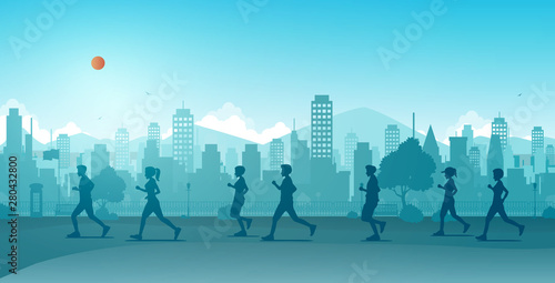 Men and women are running along the city streets.