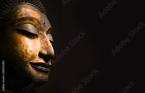 Close up Thai Ancient Solid Head of Buddha, antique bronze Buddha face of Wat Phra Si Sanphet Temple.