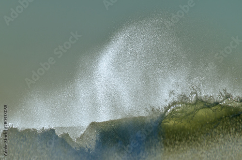 Wave spray caused by strong offshore winds hitting the tops waves is called “Spindrift” photo