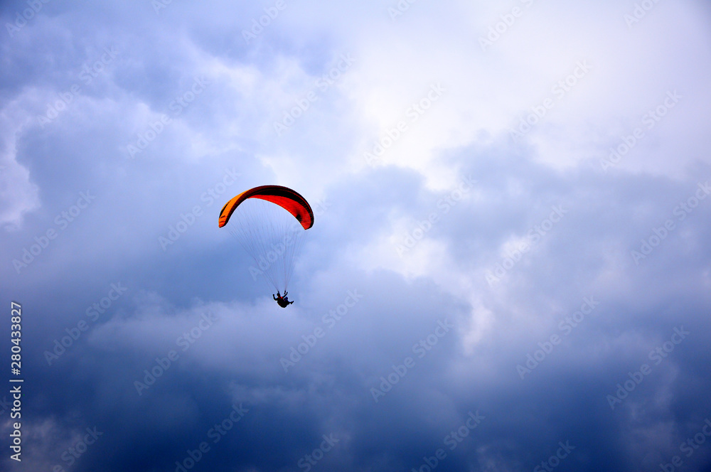 Paraglider flying in the blue sky with beautiful clouds. Paraglider flying in the blue sky with beautiful clouds.
