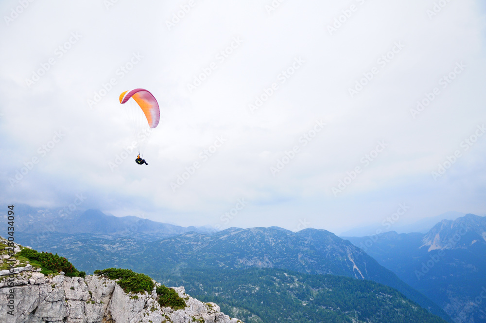 Paraglider flying over mountains in summer day. Paraglider flying over mountains in summer day.