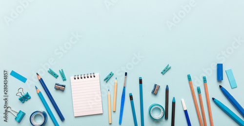 Flat lay of office, school stationery on blue background