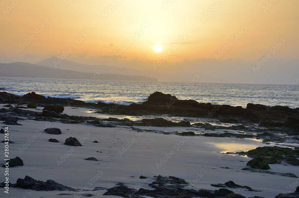 Fototapeta premium Sunrise by the Sea with Low Tide in Fuerteventura, Canary Islands