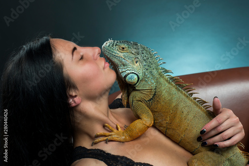 perfect bodyes sensual woman with iguana dragon in the studio