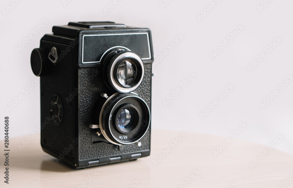 Old retro widescreen film camera on white background