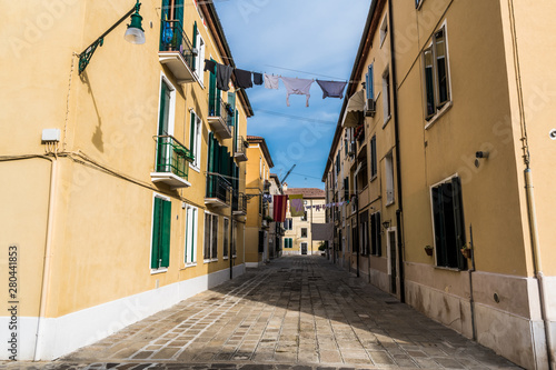 Linen is dried on a narrow street