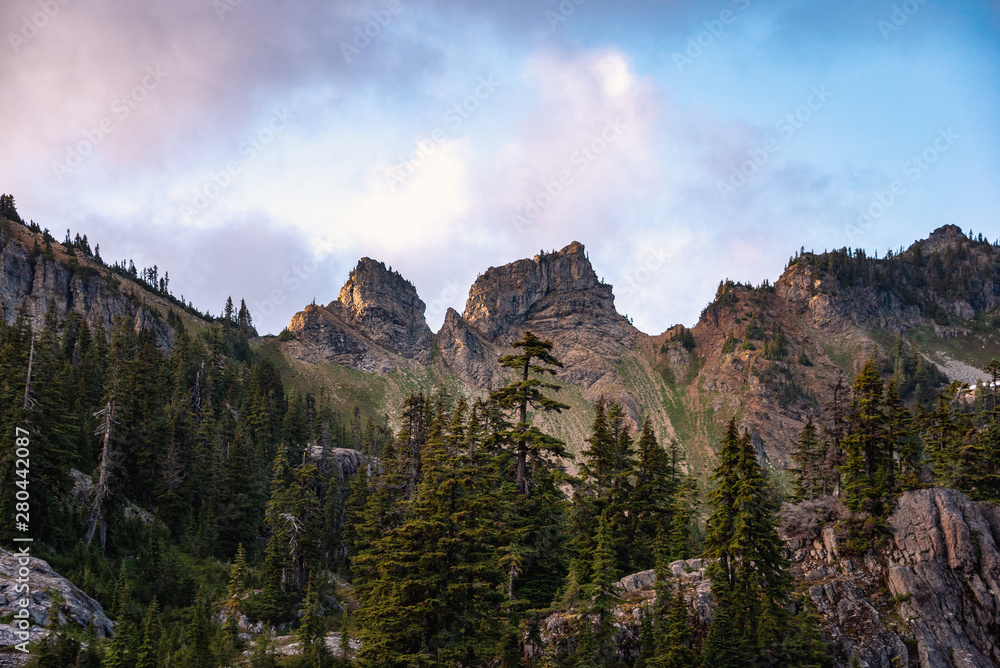 Dramatic skies over jagged peaks in the Alpine Lakes Wilderness. Central Cascade Mountain Range, Washington State, July 2019.