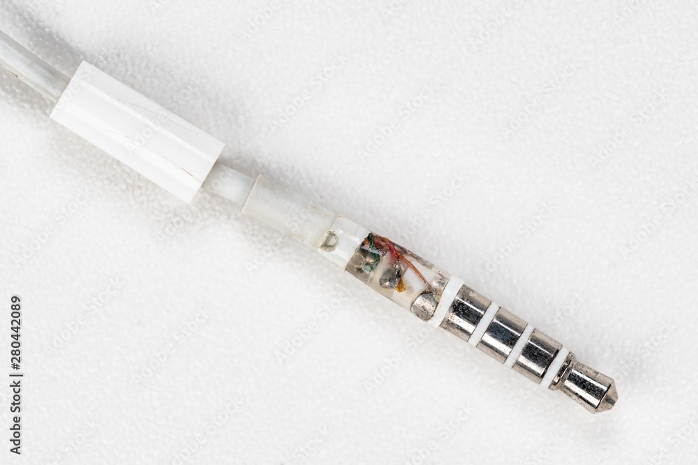 Fototapeta premium A broken headphone jack on white background.