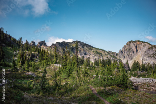 Dramatic skies over jagged peaks in the Alpine Lakes Wilderness. Central Cascade Mountain Range, Washington State, July 2019.