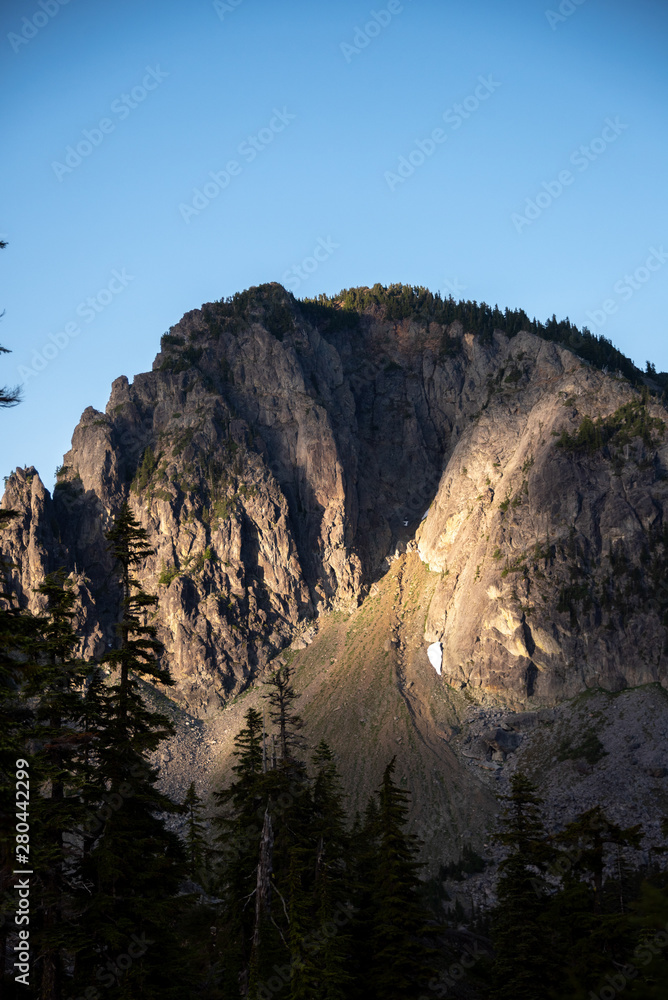 Dawn alpenglow over jagged peaks in the Alpine Lakes Wilderness. Central Cascade Mountain Range, Washington State, July 2019.