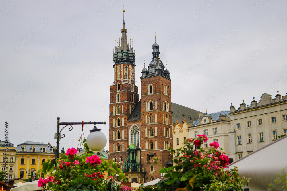 Krakow, Poland - May 21, 2019: View of flowers in the foreground, in the background the church is out of focus.