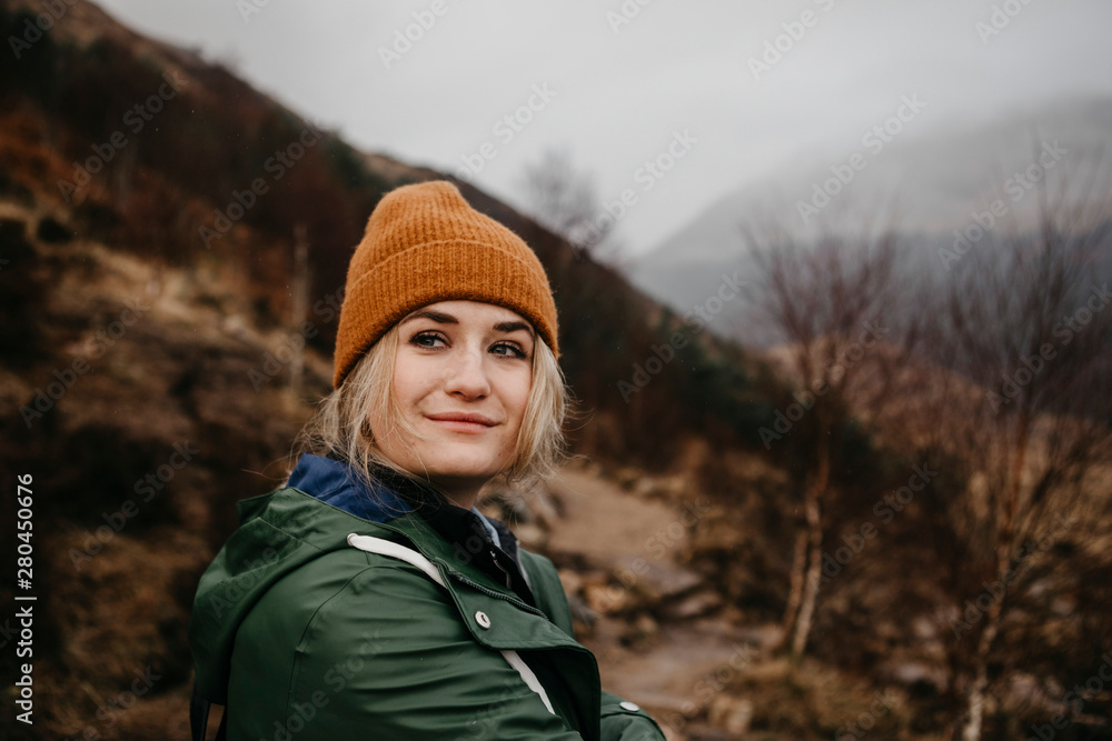 UK, Scotland, Highland, portrait of young woman in rural landscape UK, Scotland, Highland, portrait of young woman in rural landscape