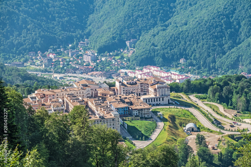 View of the hotel complex in the mountains covered with green forests