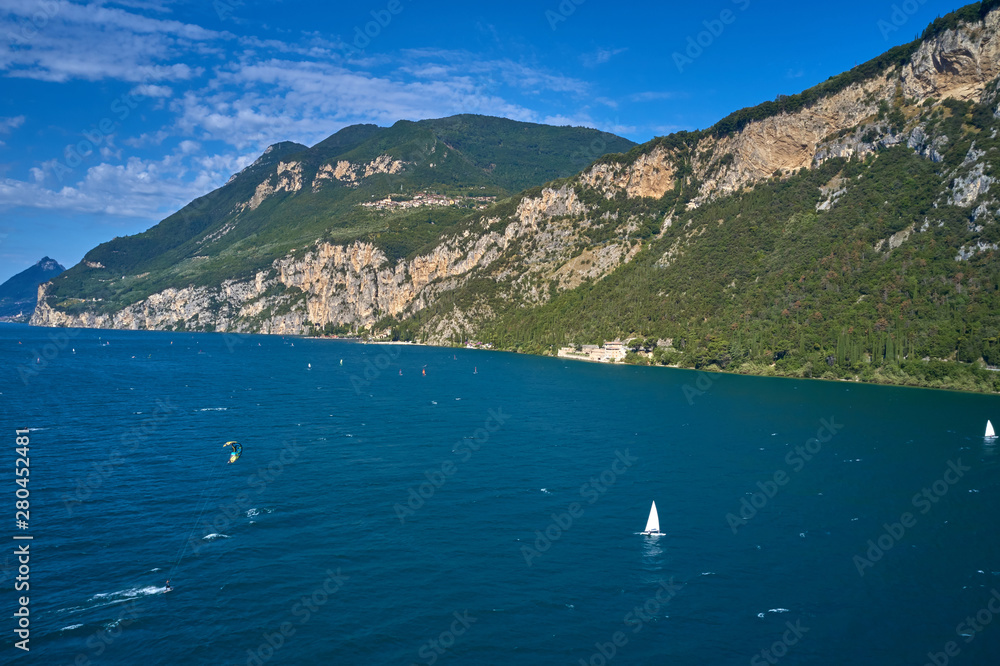 Windsurfing on the surface of the water. Competitions on Lake Garda north of Italy. Aerial photography with drone.