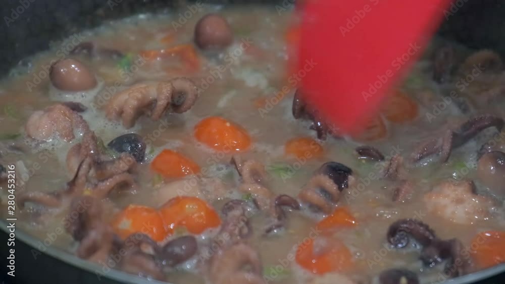 Stir fried baby octopus and vegetables boil in sauce in a hot frying pan. Cooking seafood 4k 50 frames per second narrow depth of field. Close up macro footage. Stir fried baby octopus and vegetables boil in sauce in a hot frying pan. Cooking seafood 4k 50 frames per second narrow depth of field. Close up macro footage.