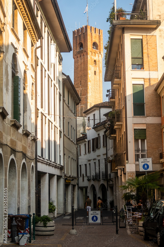 Alley in Treviso, with Battistero di San Giovanni church as backdrop. Italy
