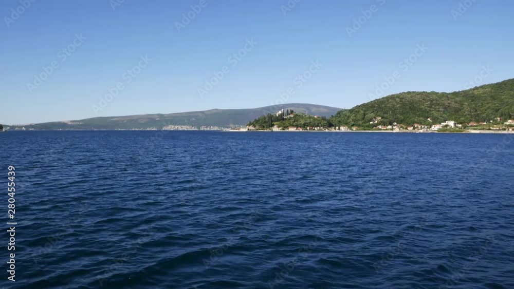 Quiet sea. View of the coast from a distance in sunny day Quiet sea. View of the coast from a distance in sunny day