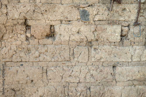 Old adobe brick wall. Texture background of an adobe close-up photo