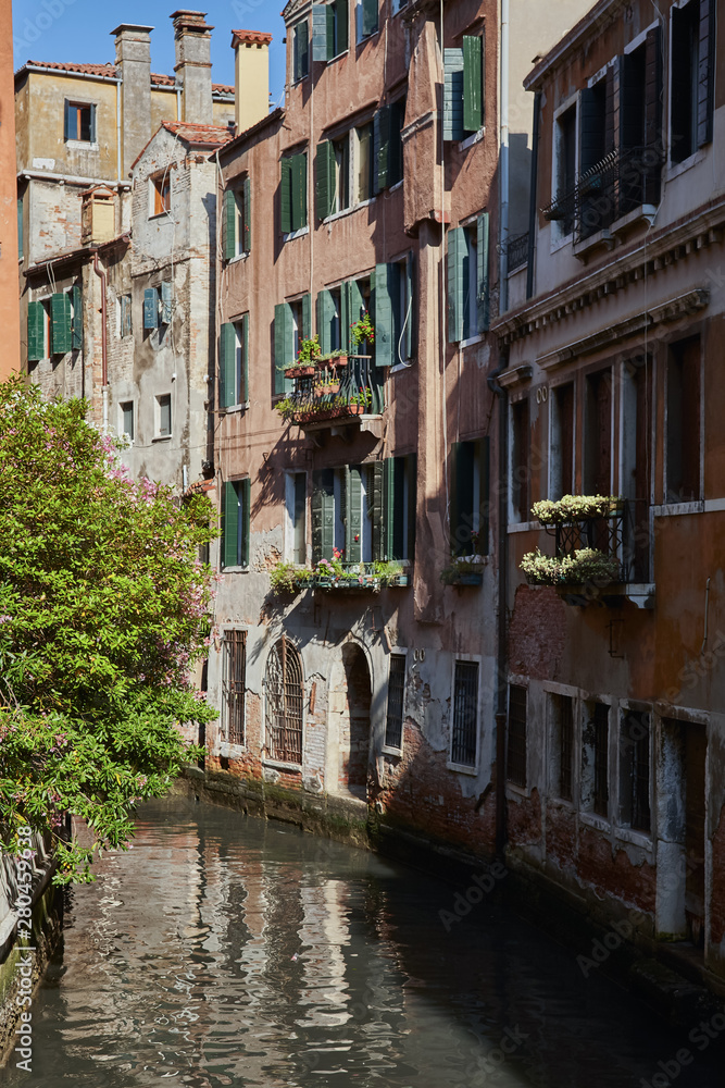 Traditional narrow canal in Venice, Italy.