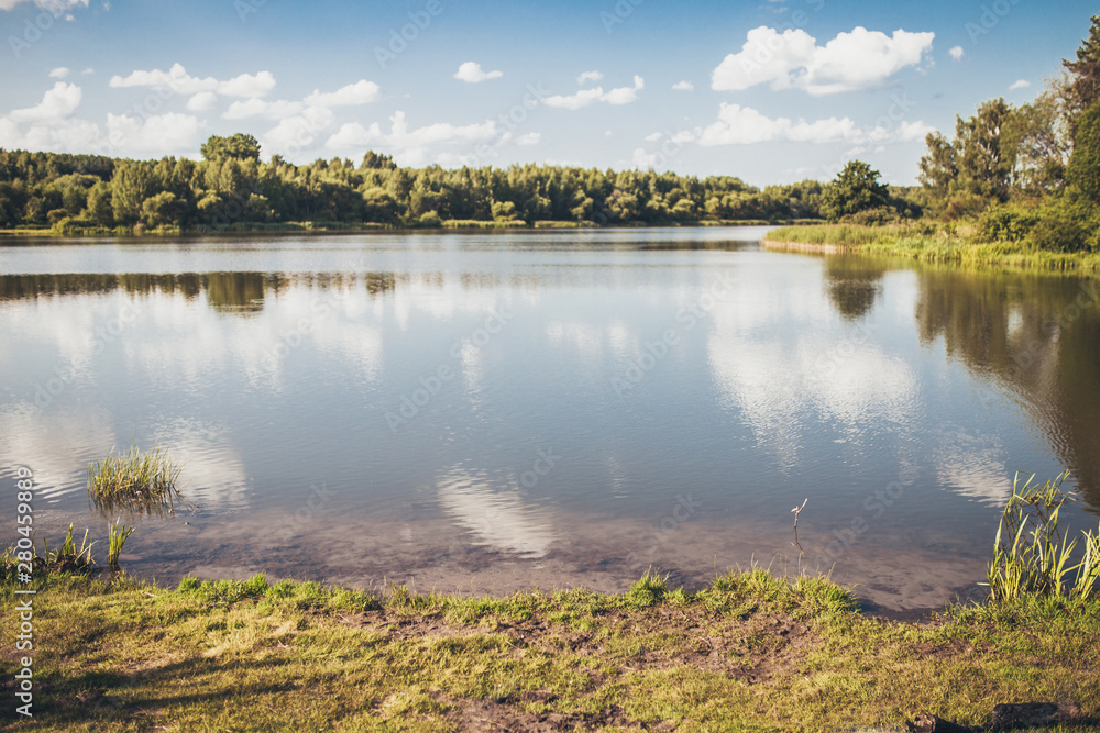 Fototapeta premium A quiet, relaxing holiday by the lake - swimming, fishing, camping