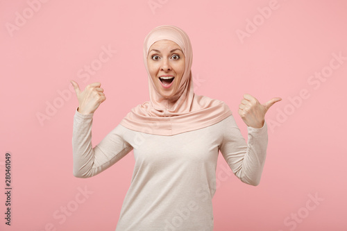 Photography Excited arabian muslim woman in hijab light clothes posing isolated on pink background