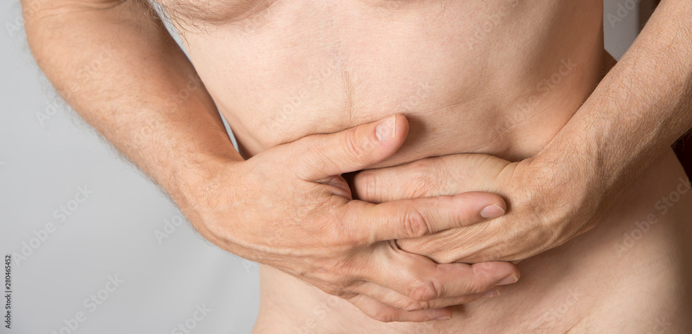Man holding his belly. Stomach and indigestion problem Man holding his belly. Stomach and indigestion problem
