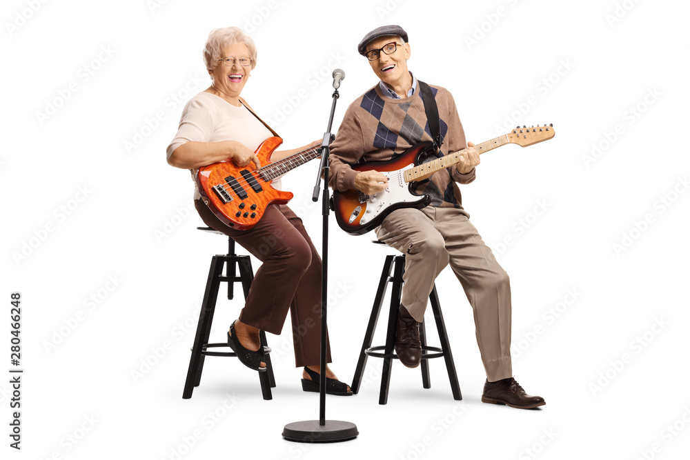 Fototapeta premium Senior man and woman sitting and playing electric guitars
