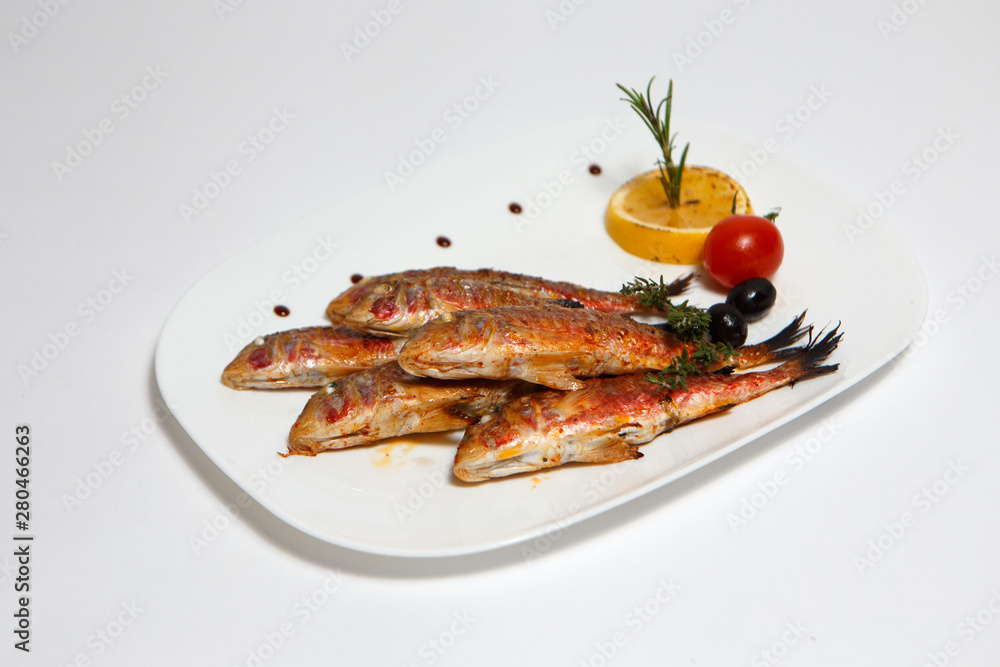 grilled lamb fish on a white plate grilled lamb fish on a white plate