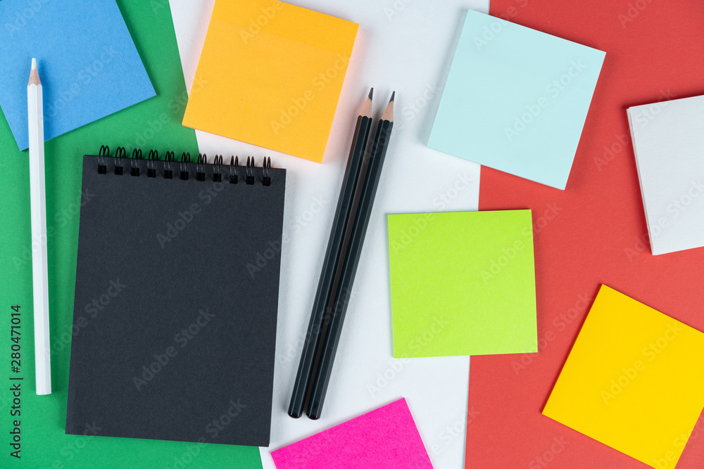 multicolored notes, black notebook and two pencils lies on Italian flag. Mock up, copy space, pattern, cardboard texture. Italian holidays concept, attractions list multicolored notes, black notebook and two pencils lies on Italian flag. Mock up, copy space, pattern, cardboard texture. Italian holidays concept, attractions list