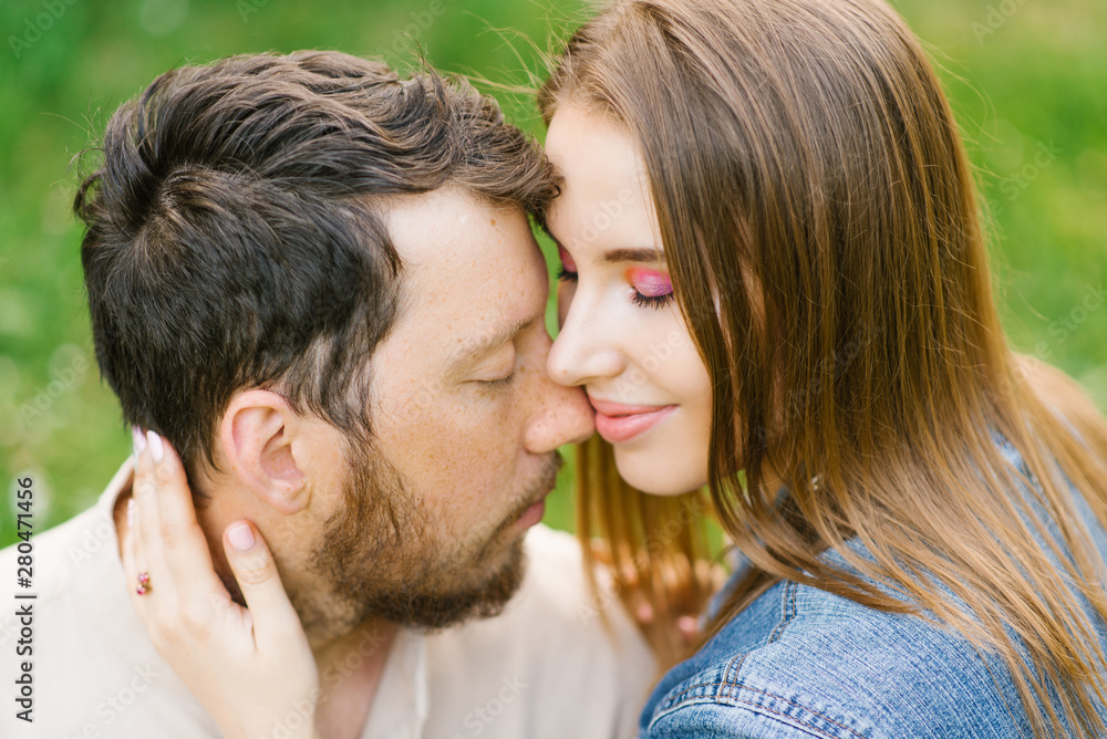 Sensual young couple enjoys a gentle warm pleasant moment of love having a romantic date, pressed their noses and foreheads, enjoy each other Sensual young couple enjoys a gentle warm pleasant moment of love having a romantic date, pressed their noses and foreheads, enjoy each other