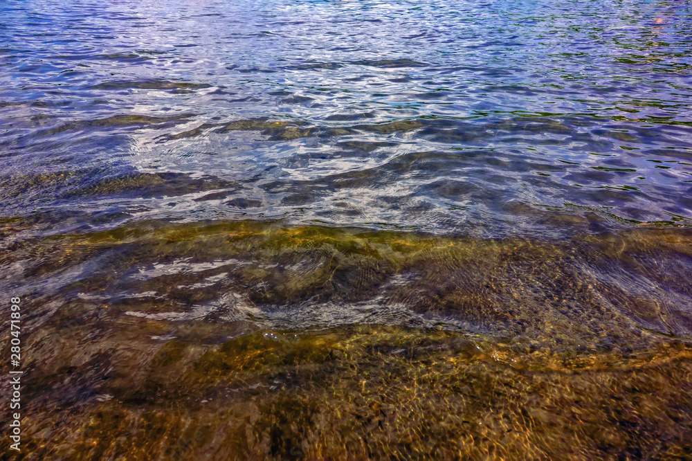 Texture of transparent water in a mountain lake. Closeup. Texture of transparent water in a mountain lake. Closeup.