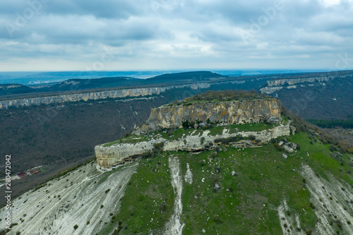 Flying drone above the cave city Tepe-Kermen, near the city of Bakhchisaray, Crimea photo