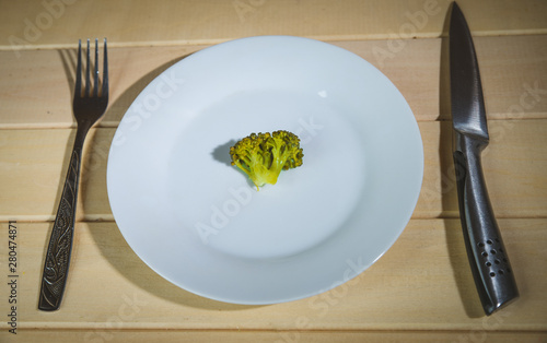 Vegetarian vegetables: broccoli, Brussels sprouts, cauliflower, carrots and green beans on a white plate and blue background. Selective focus