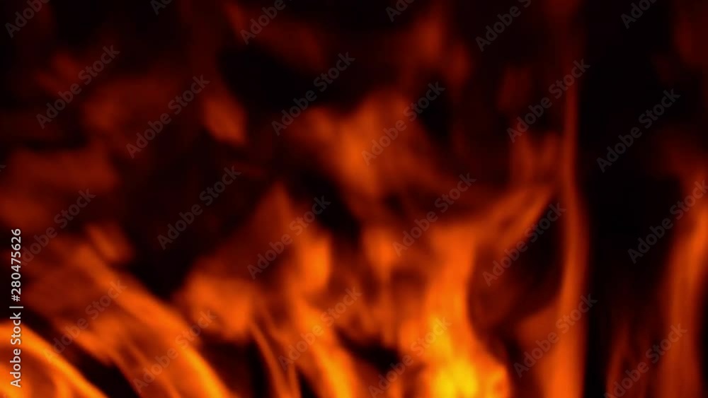 Burning wall of fire on a black background. Flames texture on a black background. Burning wall of fire on a black background. Flames texture on a black background.