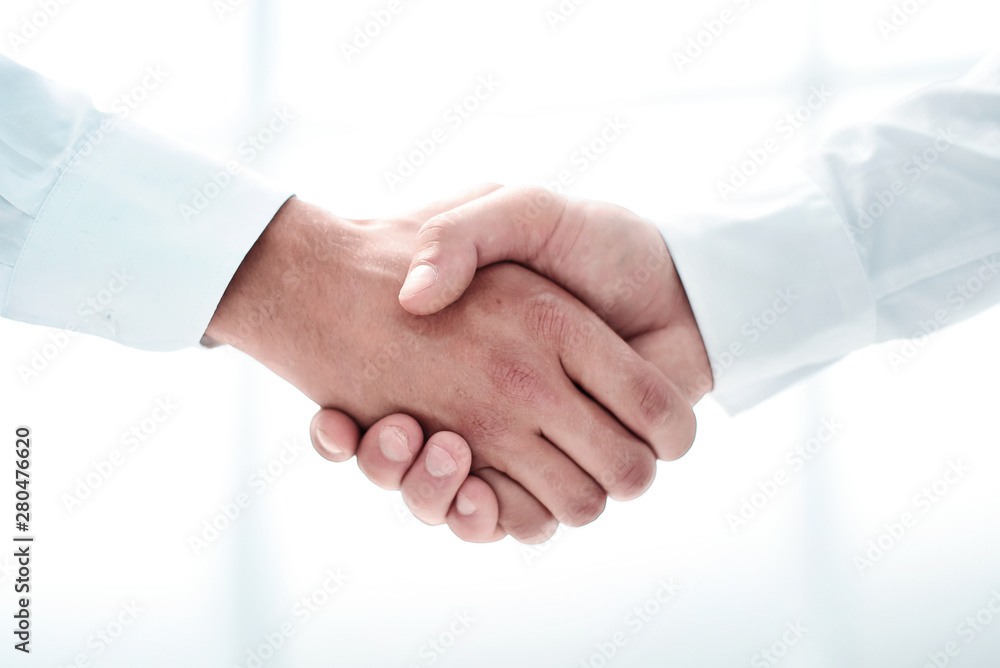 close up.handshake of business people on a light background close up.handshake of business people on a light background