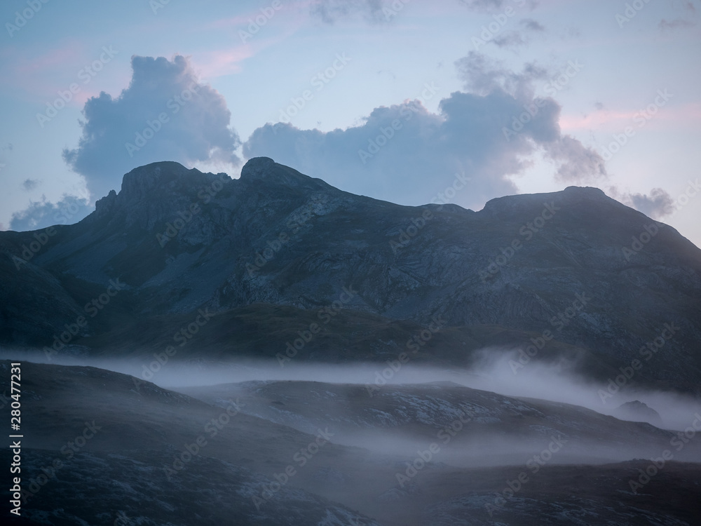 Fototapeta premium Hills of Pyrenees being covered by fog
