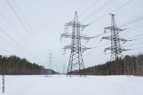 high voltage power lines at blue sky. electricity distribution station. high voltage electric transmission tower.