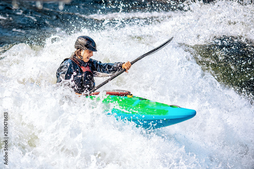Guy in kayak sails mountain river. Whitewater kayaking, extreme sport rafting © Parilov