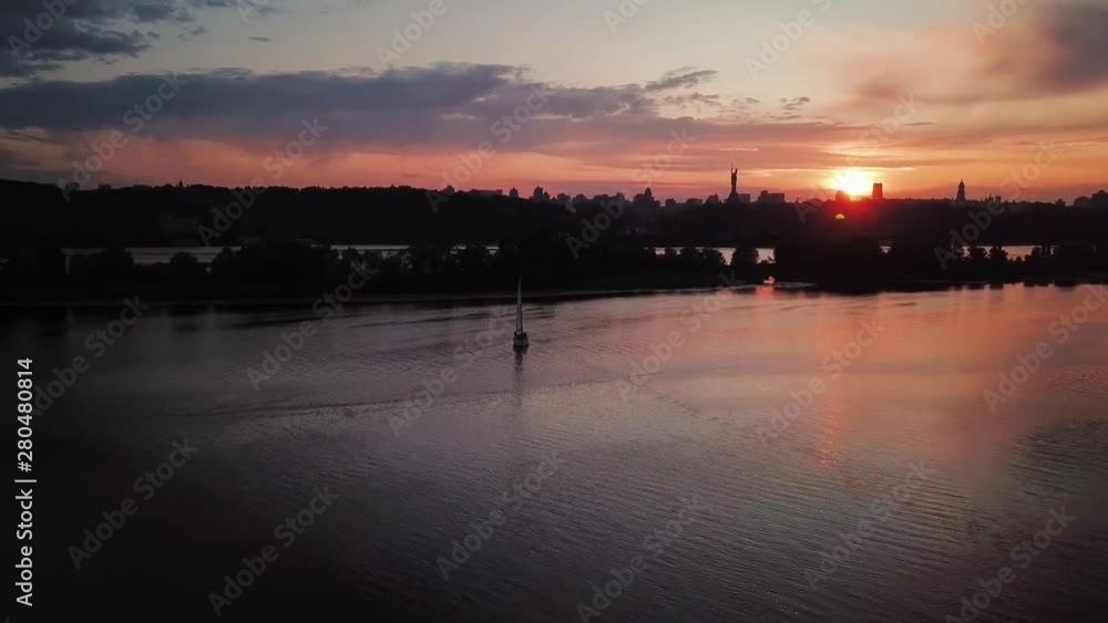 aerial city view, yacht on sunset. Drone shot,bird's eye aerial city view, yacht on sunset. Drone shot,bird's eye