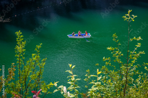 Boat sails on a lake in Ruskeala canyon in Karelia in Russia photo