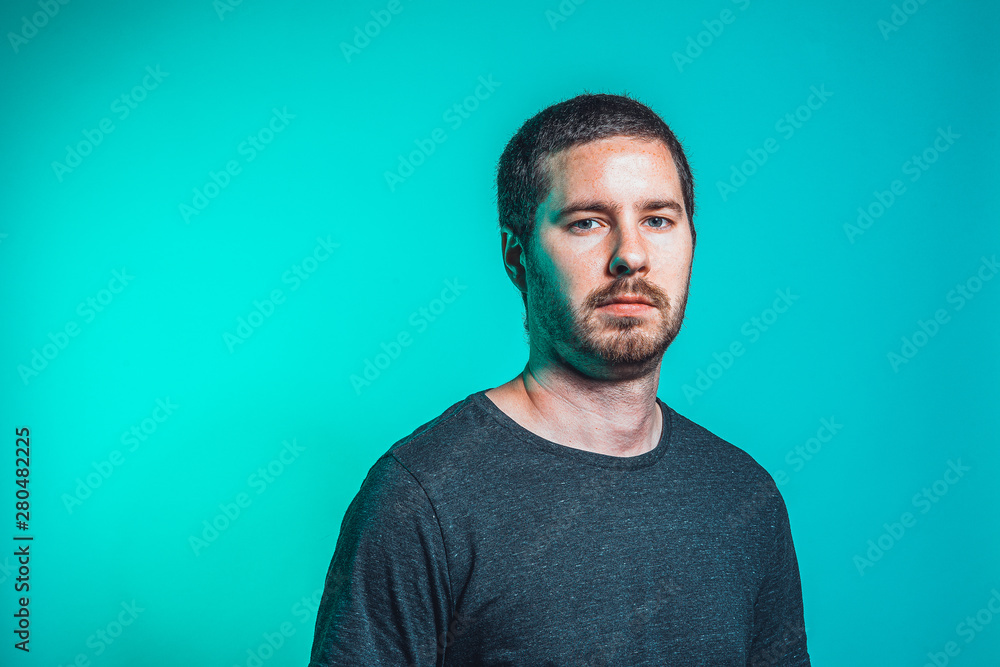 portrait of men on green background watching serious into the camera portrait of men on green background watching serious into the camera