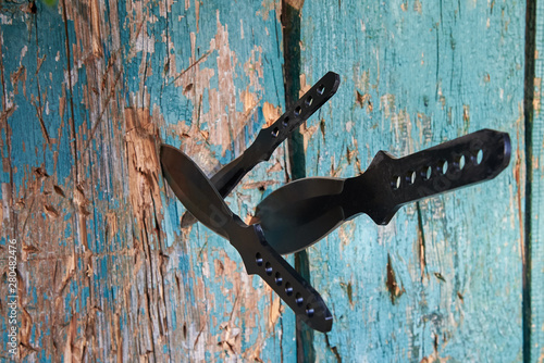 Knives for throwing different sizes in a wooden fence photo