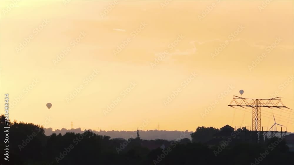 Two Hot Air Balloons on the Horizon flying into the Sunset Two Hot Air Balloons on the Horizon flying into the Sunset